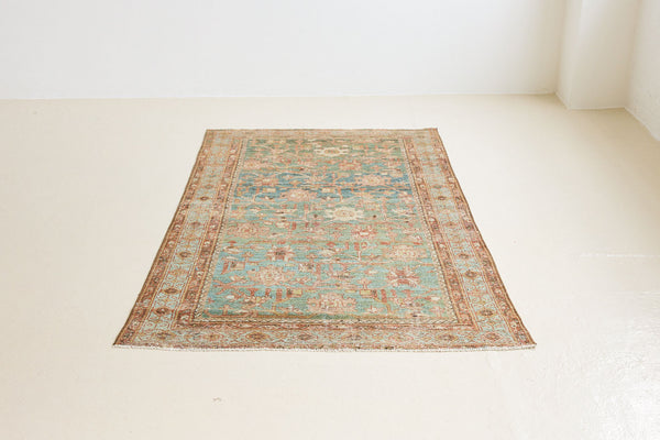 Alina an antique Persian Malayer rug with a blue field and an earthy pink intricate all over floral design