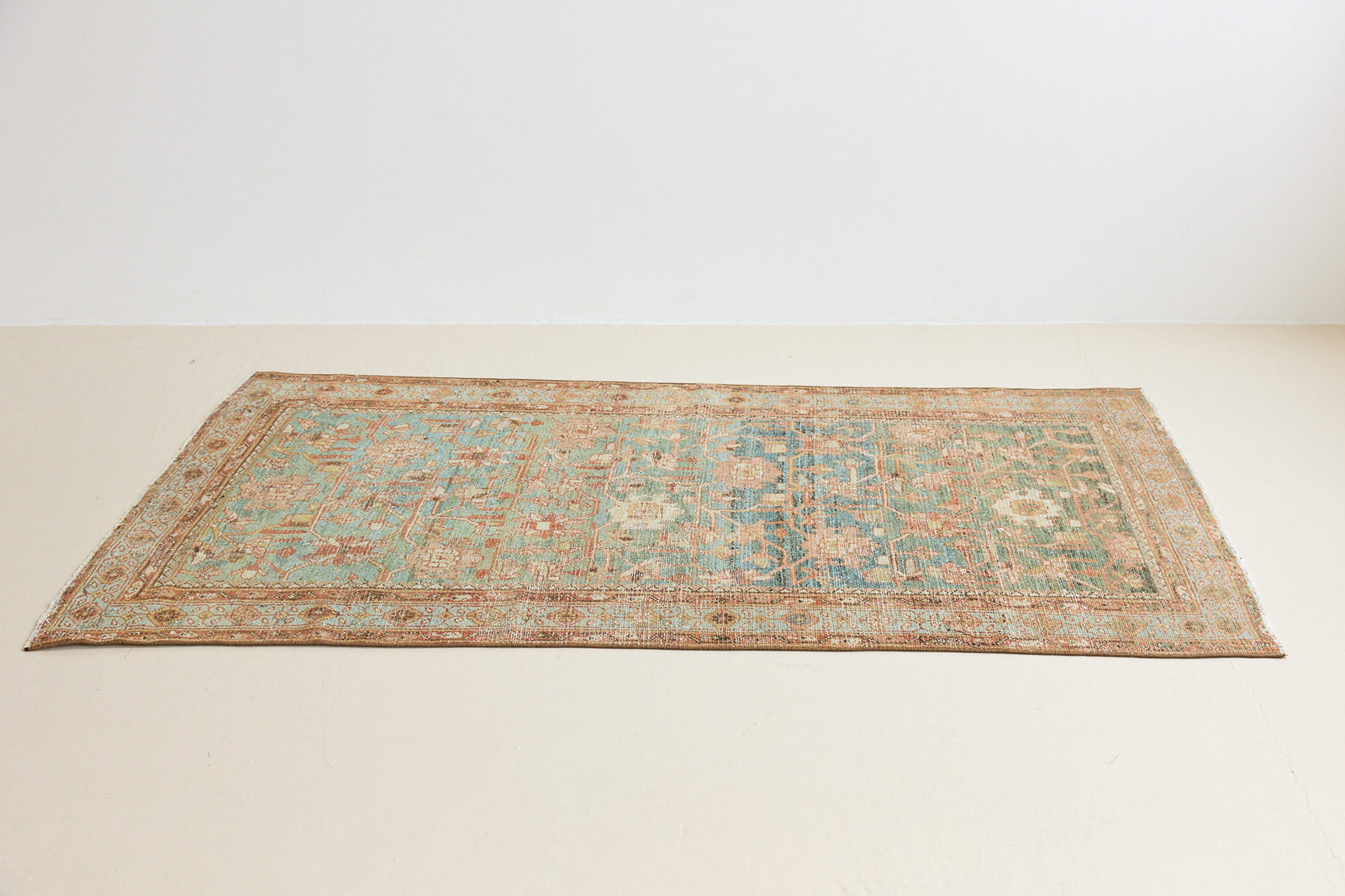 Alina an antique Persian Malayer rug with a blue field and an earthy pink intricate all over floral design