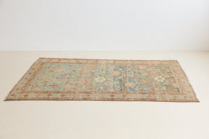 Alina an antique Persian Malayer rug with a blue field and an earthy pink intricate all over floral design