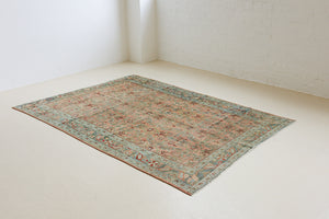 Celine is a beautiful Hamedan rug featuring a rusty pink field, blue border and a decorative all over floral design