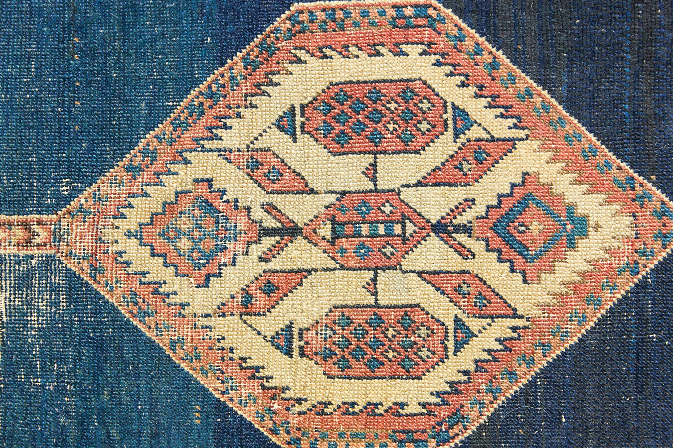 Seraphine is a beautiful antique Oushak runner with a peachy pink repeating pattern on a dark blue ground. Oushak rugs are among the most celebrated of all Turkish weavings, prized for their soft, luminous palettes and characteristically open, large-scale designs