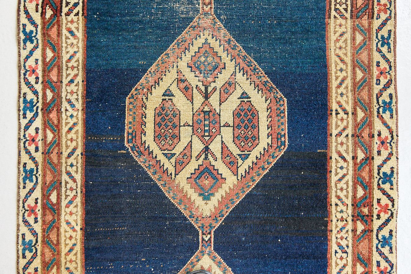 Seraphine is a beautiful antique Oushak runner with a peachy pink repeating pattern on a dark blue ground. Oushak rugs are among the most celebrated of all Turkish weavings, prized for their soft, luminous palettes and characteristically open, large-scale designs