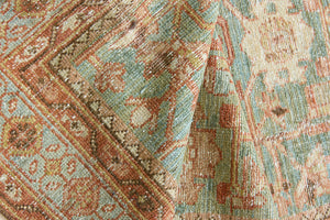 Alina an antique Persian Malayer rug with a blue field and an earthy pink intricate all over floral design