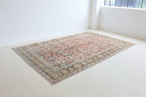 Mahals are known for decorative designs and repeating floral patterns. This antique rug features a beautiful earthy red ground complimented by a dark blue border.