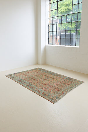 Celine is a beautiful Hamedan rug featuring a rusty pink field, blue border and a decorative all over floral design