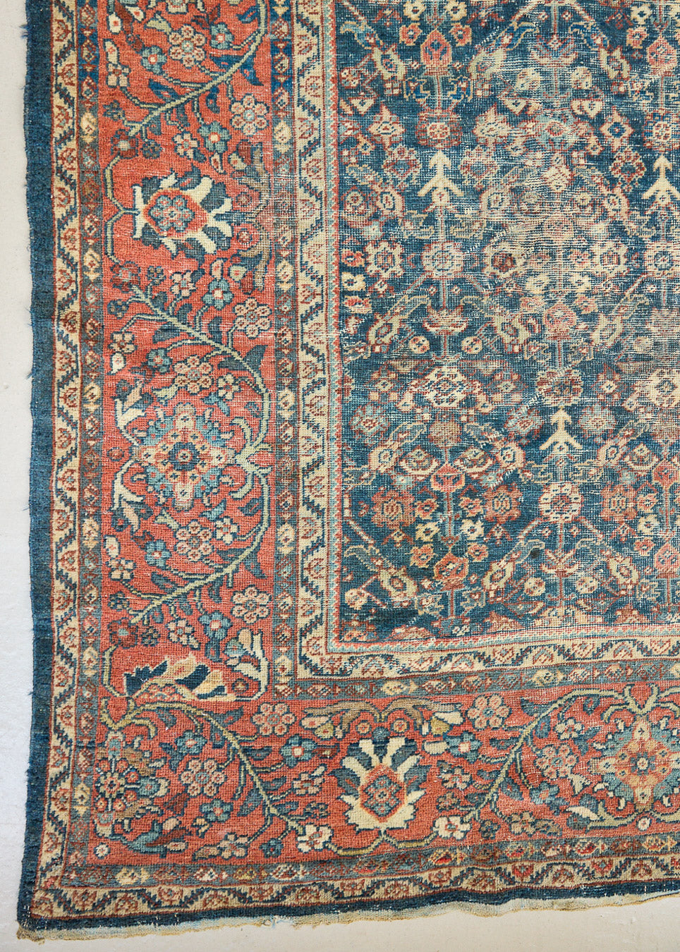 Farahan rugs are known for their high quality and are some of the most valuable Persian styles known for their repeating all over designs. Adeline is a large rug featuring a beautiful, intricate all over design on a dark blue ground with red boarder.
