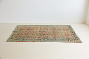 Celine is a beautiful Hamedan rug featuring a rusty pink field, blue border and a decorative all over floral design