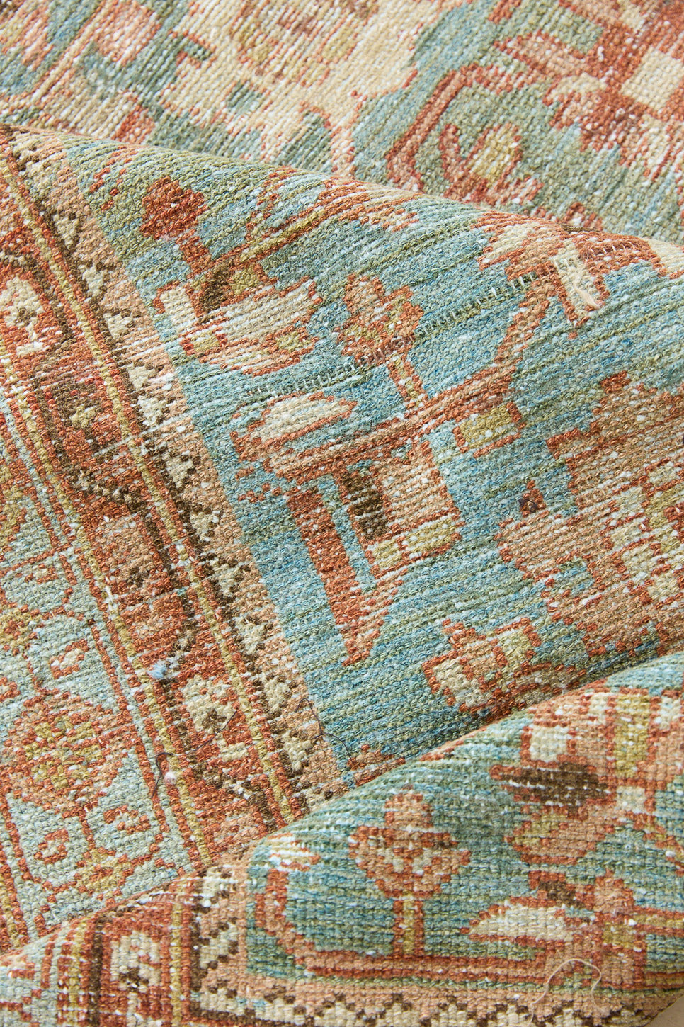 Alina an antique Persian Malayer rug with a blue field and an earthy pink intricate all over floral design