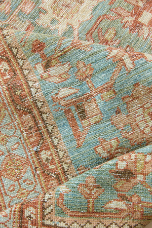 Alina an antique Persian Malayer rug with a blue field and an earthy pink intricate all over floral design