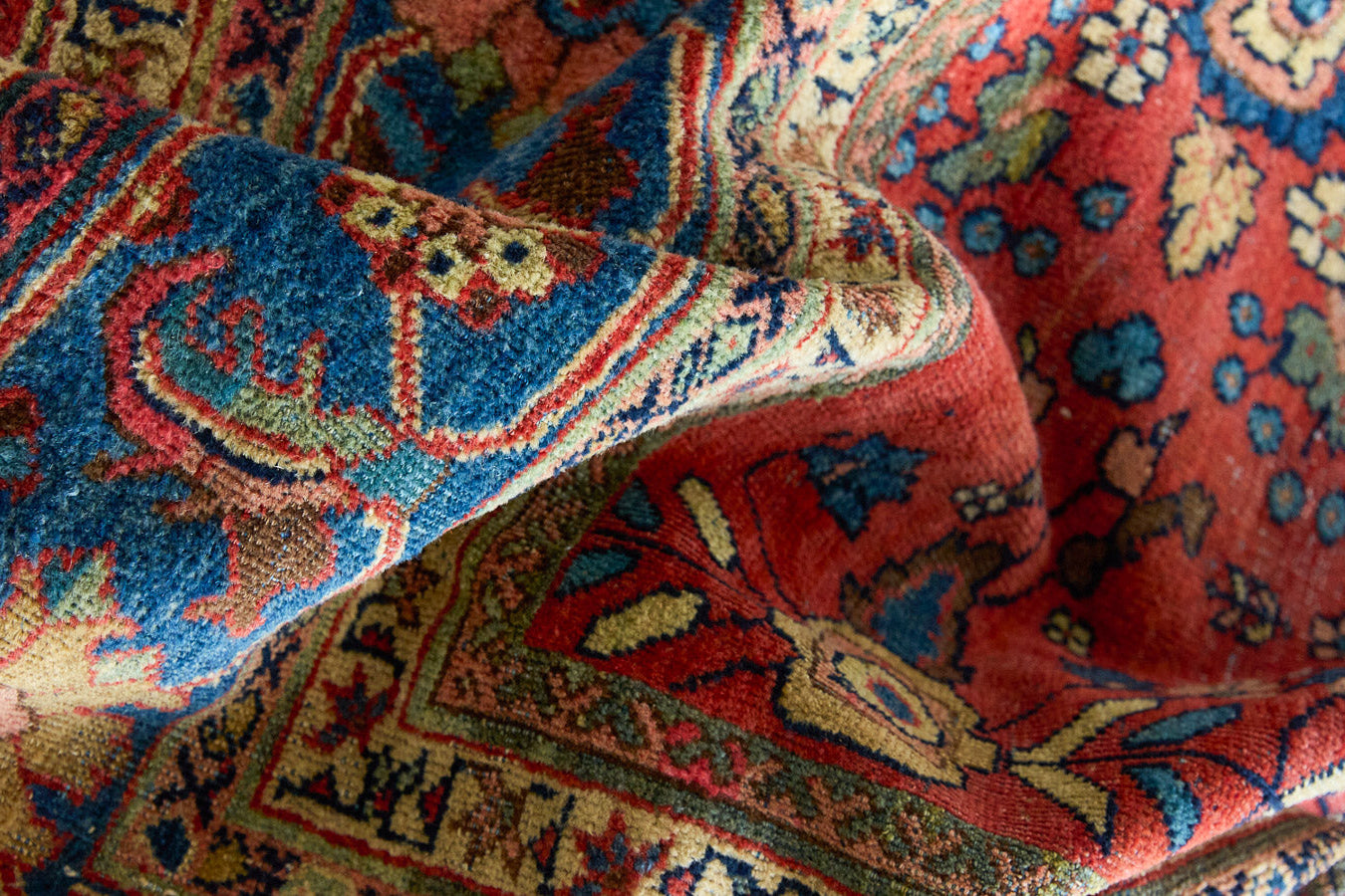 Cassiopeia is a beautiful Mahal rug featuring an all over floral design on a vibrant red field. 