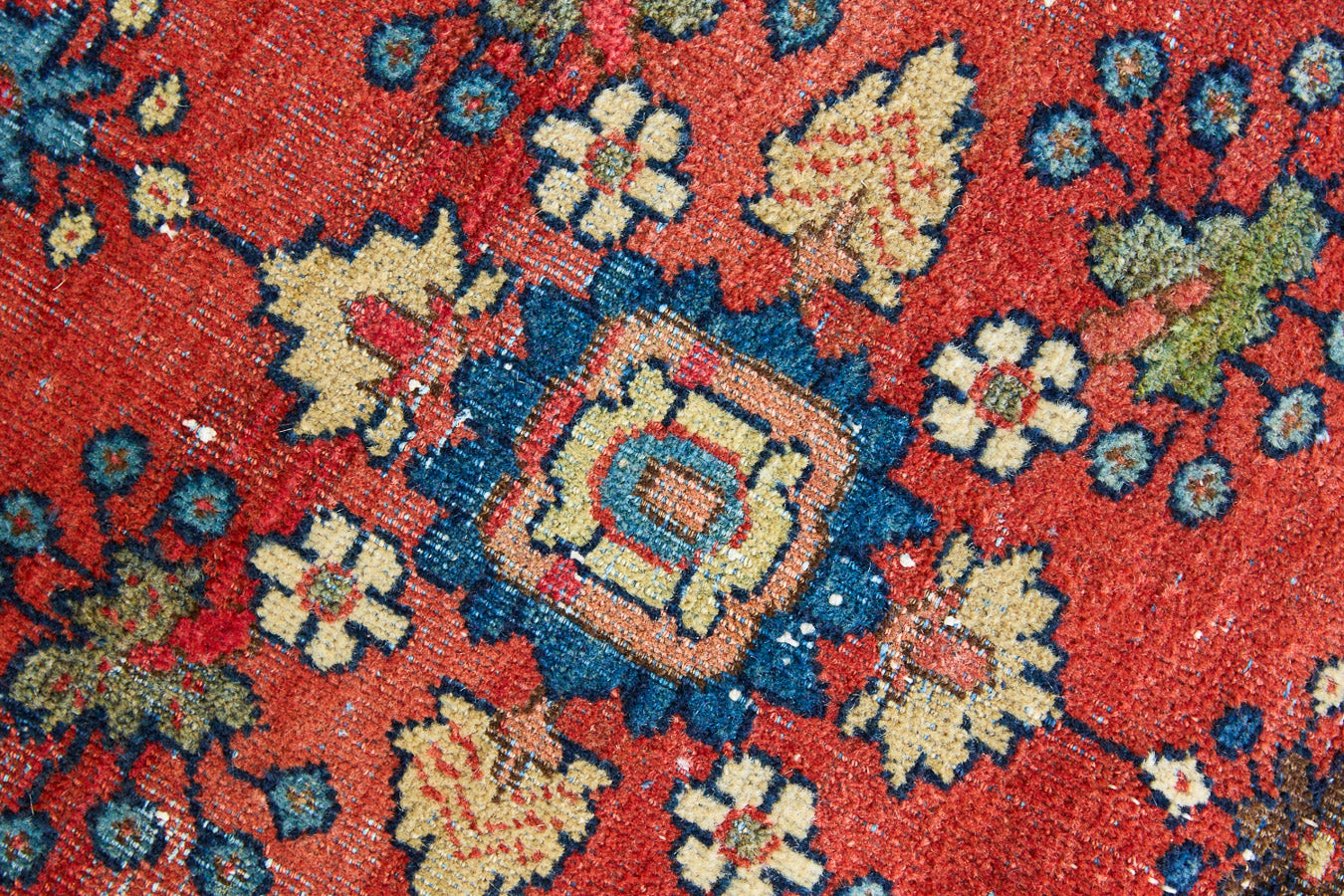 Cassiopeia is a beautiful Mahal rug featuring an all over floral design on a vibrant red field. 