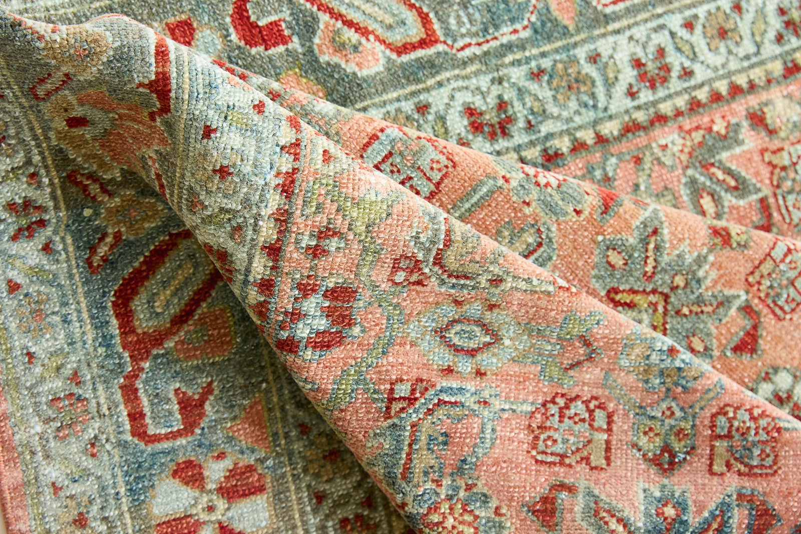 Celine is a beautiful Hamedan rug featuring a rusty pink field, blue border and a decorative all over floral design