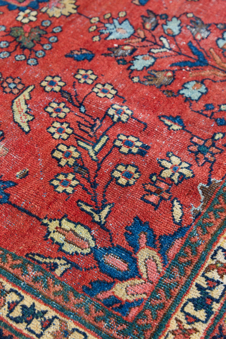 Cassiopeia is a beautiful Mahal rug featuring an all over floral design on a vibrant red field. 