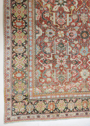 Mahals are known for decorative designs and repeating floral patterns. This antique rug features a beautiful earthy red ground complimented by a dark blue border.