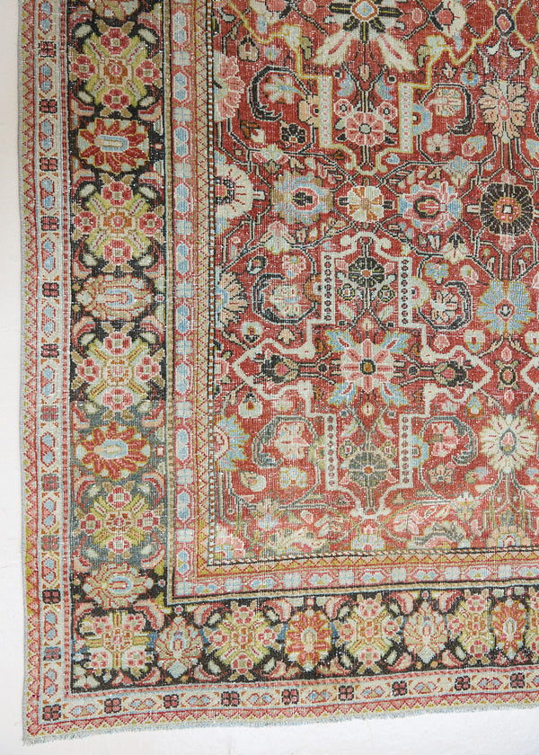Mahals are known for decorative designs and repeating floral patterns. This antique rug features a beautiful earthy red ground complimented by a dark blue border.