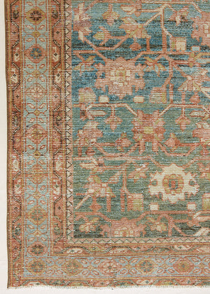 Alina an antique Persian Malayer rug with a blue field and an earthy pink intricate all over floral design. The Malayer region is known for producing some of the most ornate Persian rugs, often known for their mesmerising and intricate repeating patterns