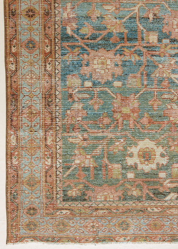 Alina an antique Persian Malayer rug with a blue field and an earthy pink intricate all over floral design. The Malayer region is known for producing some of the most ornate Persian rugs, often known for their mesmerising and intricate repeating patterns