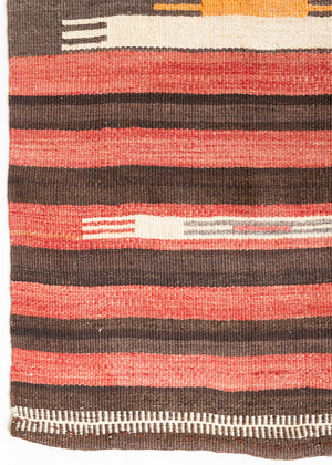 A South Anatolian nomadic kilim runner. Hand-woven on village and nomadic looms in vivid, naturally dyed colours, a tradition stretching back thousands of years. Vespa features a bold stripe pattern in earthy hues of rust, orange, taupe and black.