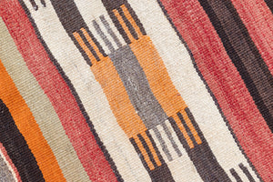 A South Anatolian nomadic kilim runner. Hand-woven on village and nomadic looms in vivid, naturally dyed colours, a tradition stretching back thousands of years. Vespa features a bold stripe pattern in earthy hues of rust, orange, taupe and black.
