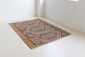 Arinna is a brightly coloured East Anatolian kilim. Hand-woven on village and nomadic looms in vivid, naturally dyed colours, a tradition stretching back thousands of years. Kilims were woven for the practicalities of daily life and used as floor and wall coverings, storage bags, and prayer mats. Arinna features the classic dragon motif, long believed to guard treasures and secret objects such as the tree of life.