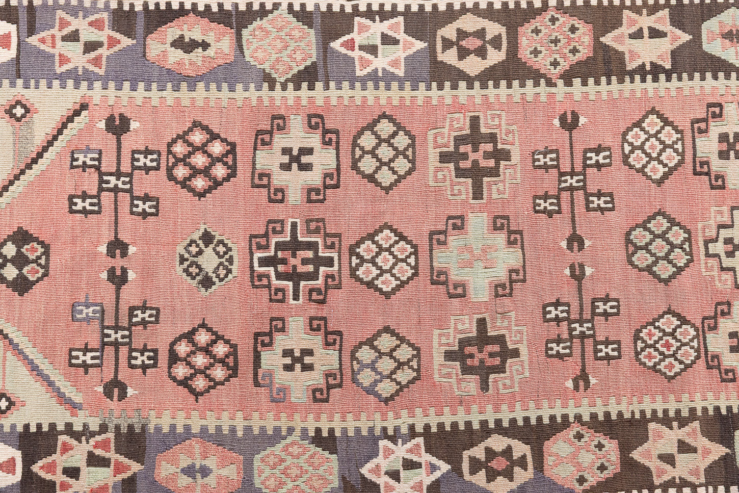 Solenne is a Central Anatolian Gömürgen Kilim rug. These kilims are hand-woven from locally sourced naturally dyed wool, a tradition stretching back thousands of years. Gömürgen kilims are known for their distinctive coal-black tones. Solenne features the classic star, eye, and comb motifs - long believed to bring happiness, ward off harm, and symbolise marriage and fertility.