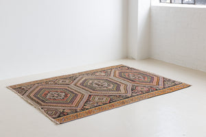 Arinna is a brightly coloured East Anatolian kilim. Hand-woven on village and nomadic looms in vivid, naturally dyed colours, a tradition stretching back thousands of years. Kilims were woven for the practicalities of daily life and used as floor and wall coverings, storage bags, and prayer mats. Arinna features the classic dragon motif, long believed to guard treasures and secret objects such as the tree of life.
