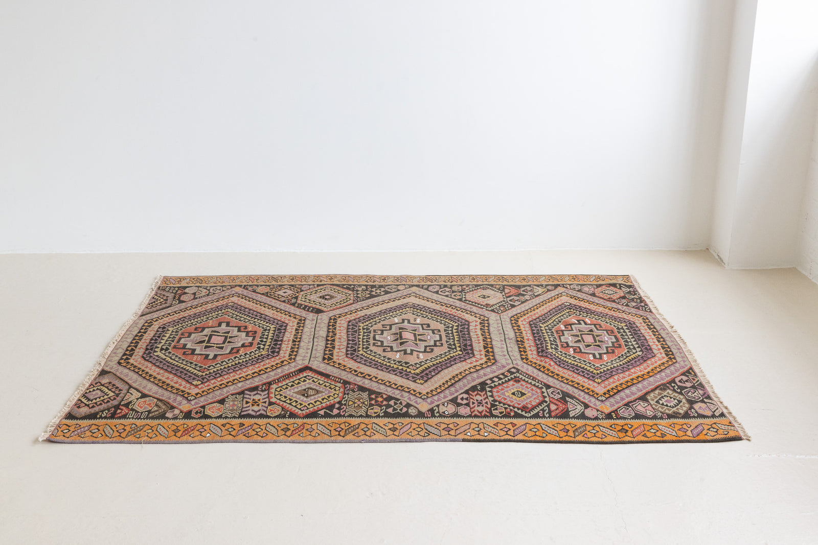 Arinna is a brightly coloured East Anatolian kilim. Hand-woven on village and nomadic looms in vivid, naturally dyed colours, a tradition stretching back thousands of years. Kilims were woven for the practicalities of daily life and used as floor and wall coverings, storage bags, and prayer mats. Arinna features the classic dragon motif, long believed to guard treasures and secret objects such as the tree of life.&nbsp;