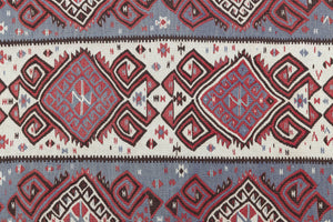 Zerrin is a bold, geometric Anatolian Hakkari kilim rug. This antique carpet features a taupe and grey striped field scattered with the classic hand-on-hips motif, bordered by the comb motif both traditionally associated with marriage and fertility.