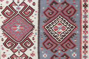 Zerrin is a bold, geometric Anatolian Hakkari kilim rug. This antique carpet features a taupe and grey striped field scattered with the classic hand-on-hips motif, bordered by the comb motif both traditionally associated with marriage and fertility.