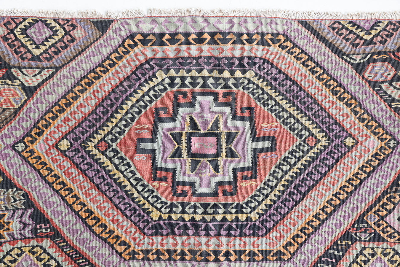 Arinna is a brightly coloured East Anatolian kilim. Hand-woven on village and nomadic looms in vivid, naturally dyed colours, a tradition stretching back thousands of years. Kilims were woven for the practicalities of daily life and used as floor and wall coverings, storage bags, and prayer mats. Arinna features the classic dragon motif, long believed to guard treasures and secret objects such as the tree of life.