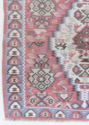 Melissa is an Anatolian Hakkari kilim rug with a Senneh design. Hand-woven on village and nomadic looms in vivid, naturally dyed colours. Kilims were woven for the practicalities of daily life and used as floor and wall coverings, storage bags, and prayer mats. Melissa features a soft pink field scattered with the classic Anatolian fertility motif, set within a soft purple border depicting the eye motif, traditionally used to protect from harm.