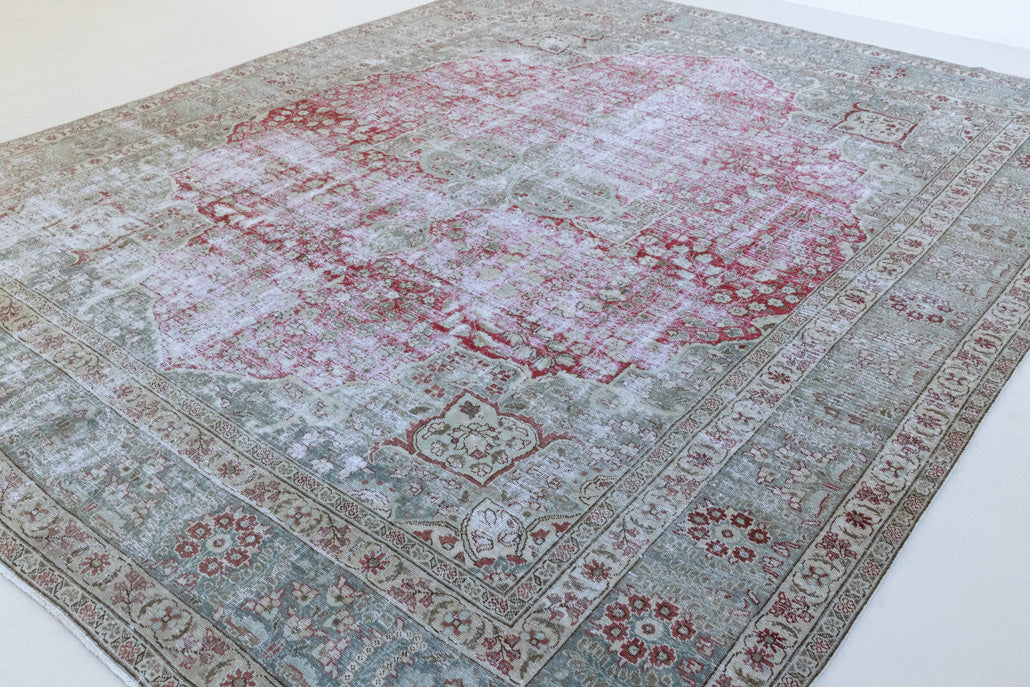 This is a handmade vintage Tabriz rug woven in Persia. The Tabriz region is known for producing some of the most ornate Persian carpet, often known for their mesmerising and intricate repeating patterns.