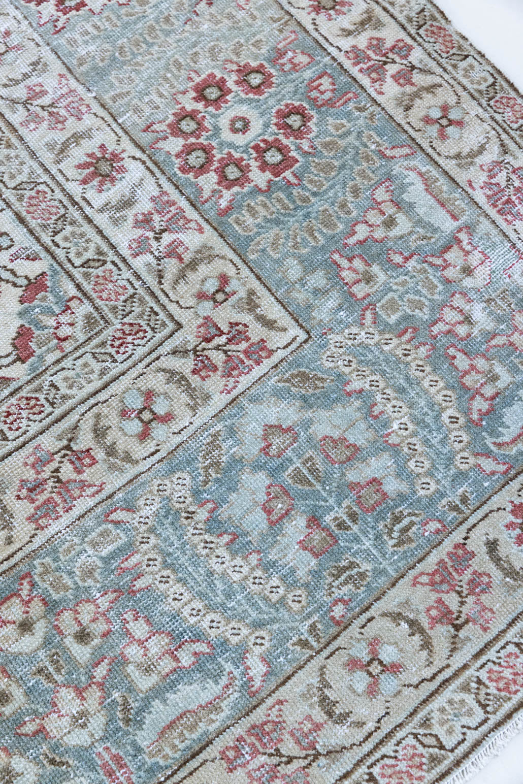 This is a handmade vintage Tabriz rug woven in Persia. The Tabriz region is known for producing some of the most ornate Persian carpet, often known for their mesmerising and intricate repeating patterns.