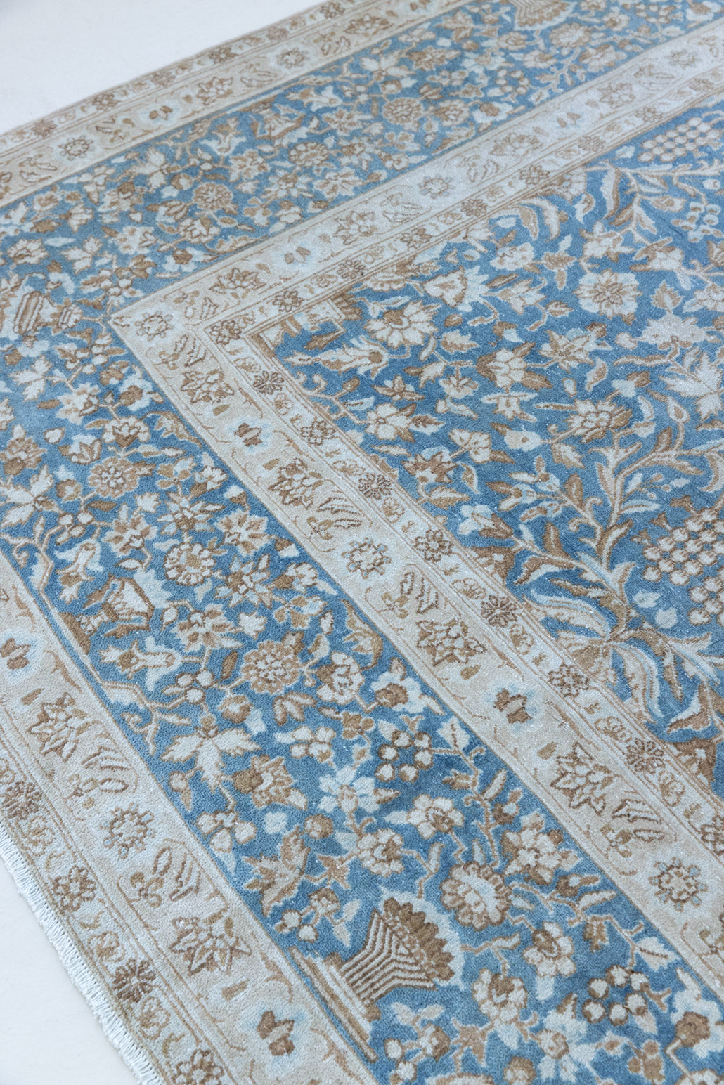 Tess is an original oversized Persian Kerman rugs from the the south east of Kerman, carpets from this part of Persia often feature very intricate floral designs. This is a lovely rug with muted tones.