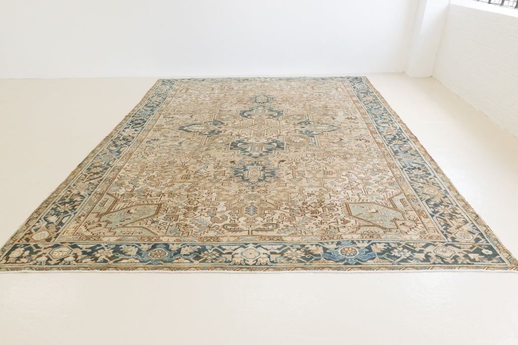 This is a vintage Persian Heriz rug that has been over-dyed to gently fade its original colours, giving a more neutral palette. Persia has the most desirable rugs and carpets with stunning designs such as this carpet. Now available at Ourika London.