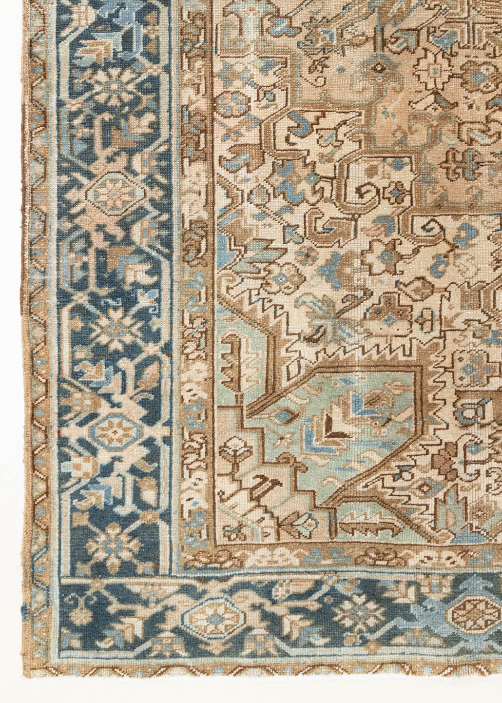 This is a vintage Persian Heriz rug that has been over-dyed to gently fade its original colours, giving a more neutral palette. Persia has the most desirable rugs and carpets with stunning designs such as this carpet. Now available at Ourika London.