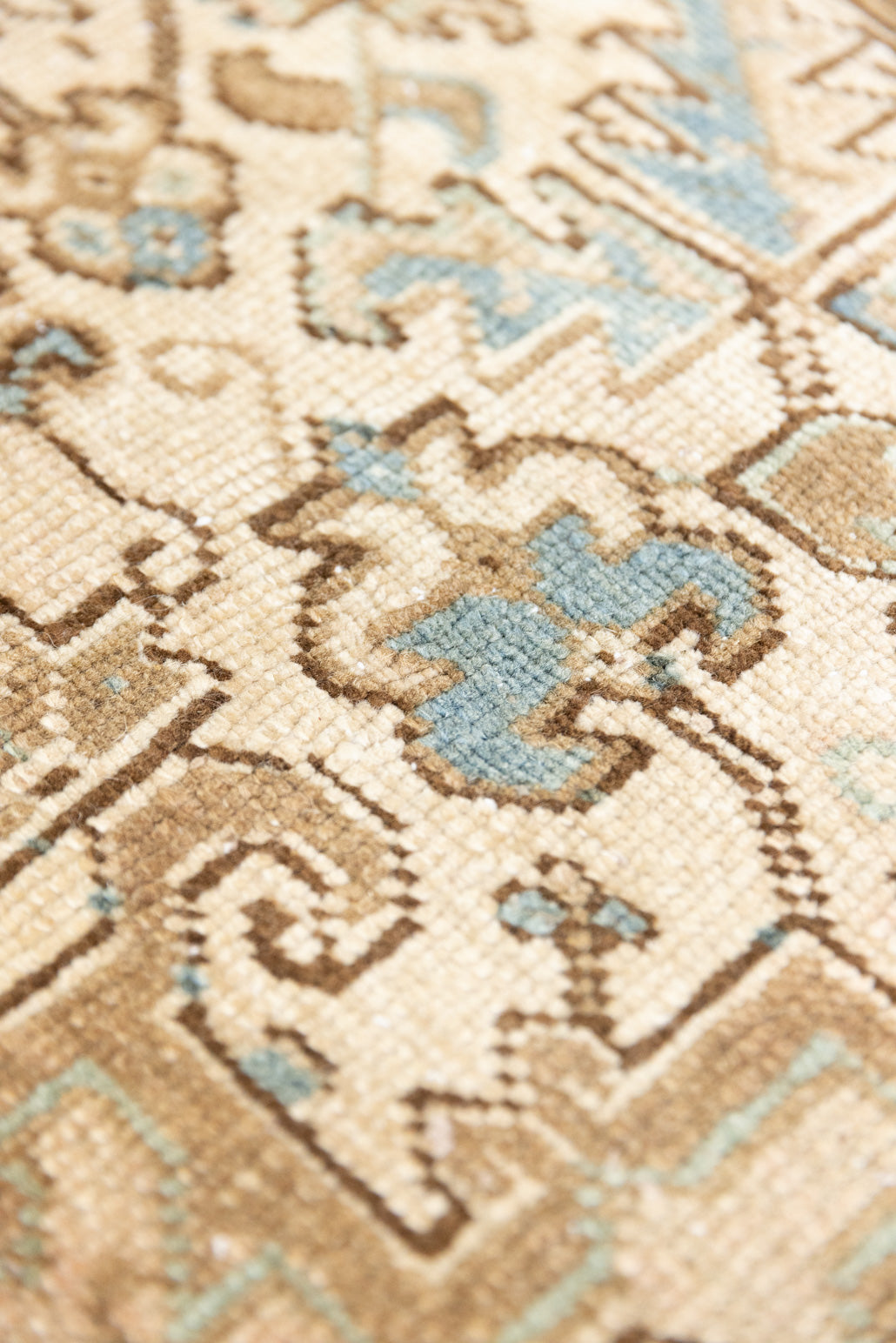 This is a vintage Persian Heriz rug that has been over-dyed to gently fade its original colours, giving a more neutral palette. Persia has the most desirable rugs and carpets with stunning designs such as this carpet. Now available at Ourika London.