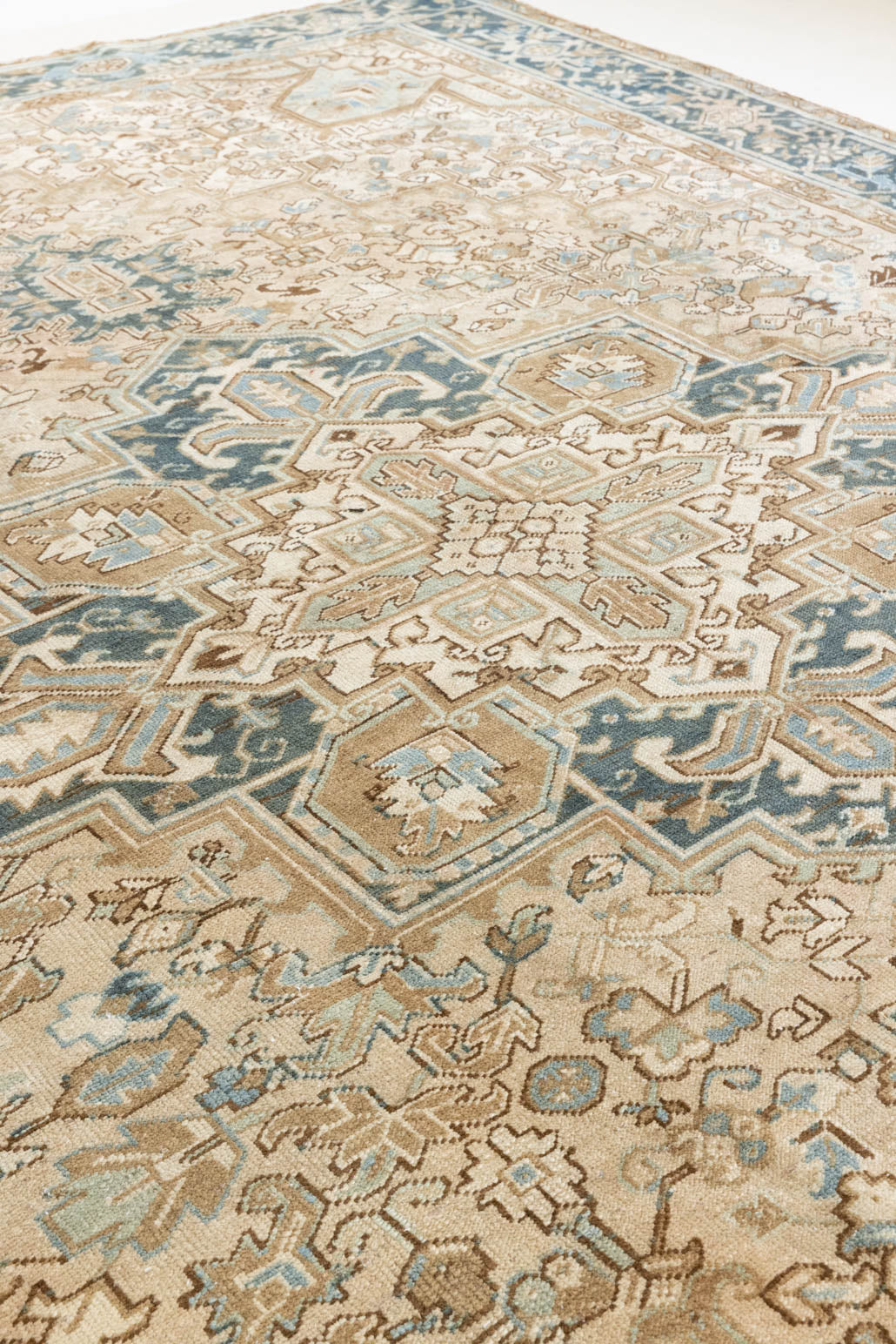 This is a vintage Persian Heriz rug that has been over-dyed to gently fade its original colours, giving a more neutral palette. Persia has the most desirable rugs and carpets with stunning designs such as this carpet. Now available at Ourika London.