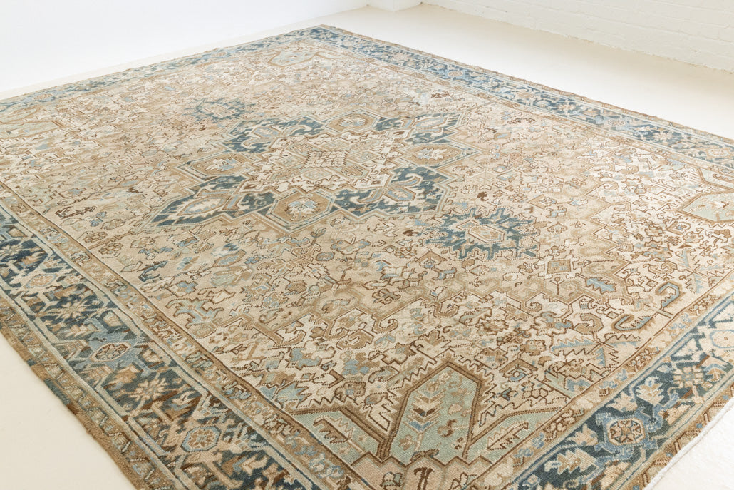 This is a vintage Persian Heriz rug that has been over-dyed to gently fade its original colours, giving a more neutral palette. Persia has the most desirable rugs and carpets with stunning designs such as this carpet. Now available at Ourika London.
