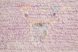 A vintage Boujad rug with a floral and geometric pattern, primarily in shades of pink and orange, showcasing natural dyes.