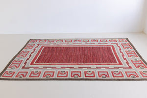 A rare vintage Swedish flatweave rug with a geometric Greek revival pattern in red, gray, and beige colours, featuring a wide border. By designer Aina Kånge