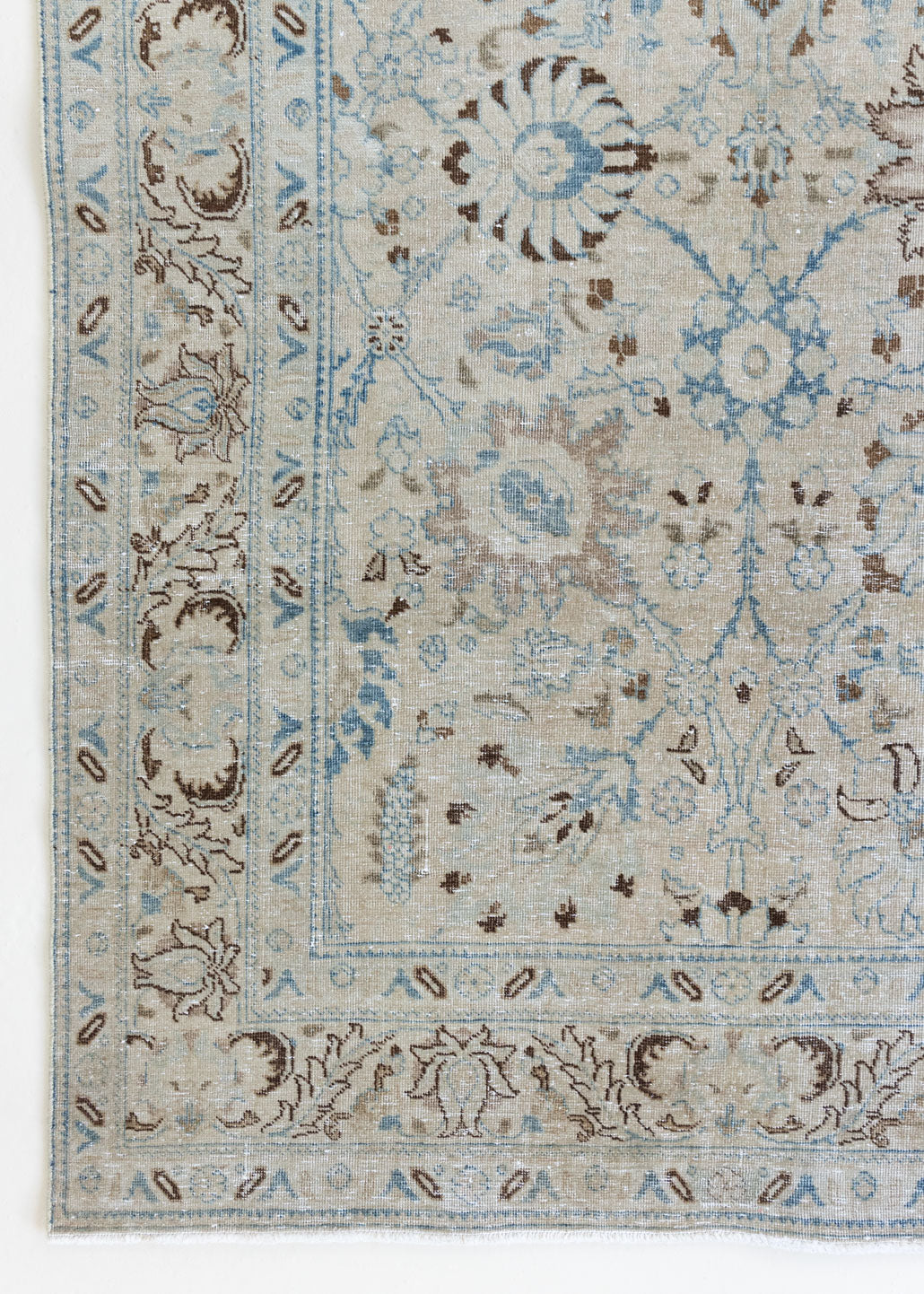 This pair of vintage handknotted Persian rugs are from the Tabriz region. Perisa is one of the oldest rug weaving centres in the world featuring floral patterns and muted colours as seen on these carpets.