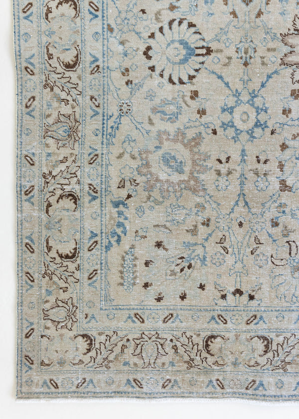 This pair of vintage handknotted Persian rugs are from the Tabriz region. Perisa is one of the oldest rug weaving centres in the world featuring floral patterns and muted colours as seen on these carpets.