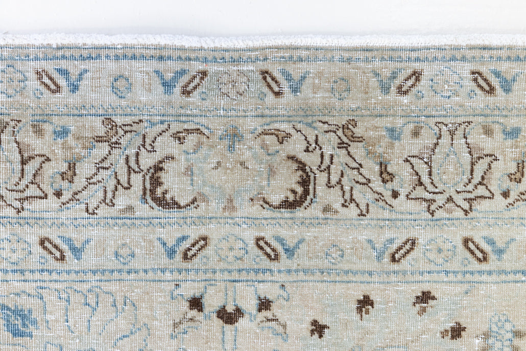 This pair of vintage handknotted Persian rugs are from the Tabriz region. Perisa is one of the oldest rug weaving centres in the world featuring floral patterns and muted colours as seen on these carpets.