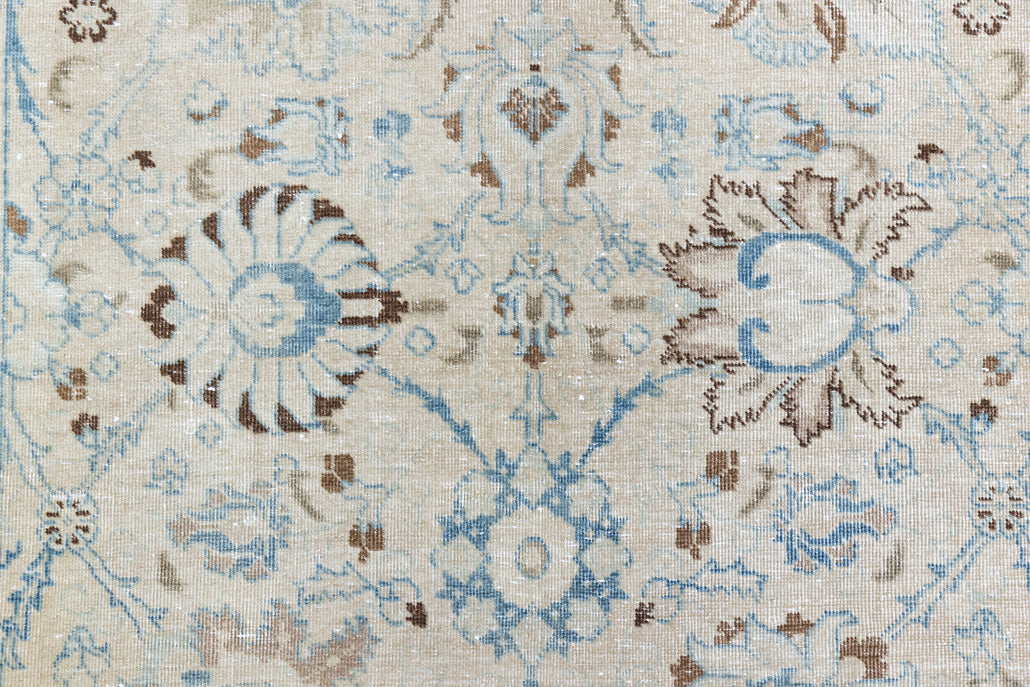 This pair of vintage handknotted Persian rugs are from the Tabriz region. Perisa is one of the oldest rug weaving centres in the world featuring floral patterns and muted colours as seen on these carpets.