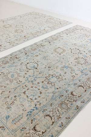This pair of vintage handknotted Persian rugs are from the Tabriz region. Perisa is one of the oldest rug weaving centres in the world featuring floral patterns and muted colours as seen on these carpets.
