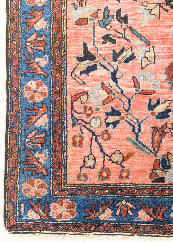 Lilian rugs were handwoven in a small village in Western Iran and often feature floral and geometric patterns as seen here. This small vintage carpet features a soft pink and blue colour palette and an intricate design inspired by nature.