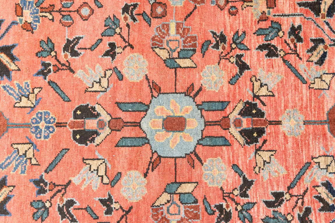 Lilian rugs were handwoven in a small village in Western Iran and often feature floral and geometric patterns as seen here. This small vintage carpet features a soft pink and blue colour palette and an intricate design inspired by nature.