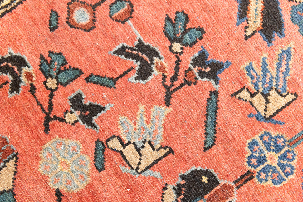 Lilian rugs were handwoven in a small village in Western Iran and often feature floral and geometric patterns as seen here. This small vintage carpet features a soft pink and blue colour palette and an intricate design inspired by nature.