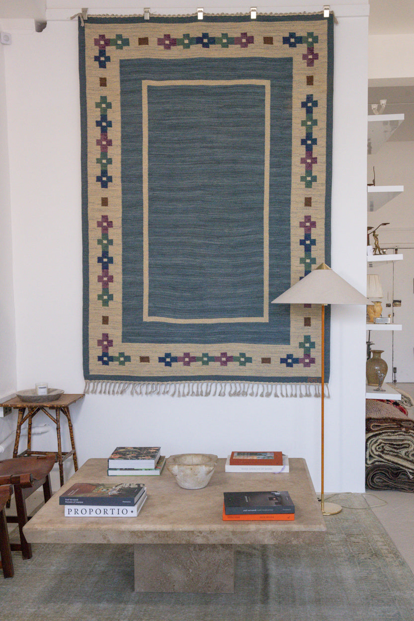 Lumi is a signed vintage Swedish flatweave rug by Anna-Greta Sjöqvist, featuring a calm blue field framed by ivory borders and delicate geometric motifs. Handwoven in wool using the traditional rölakan technique.
